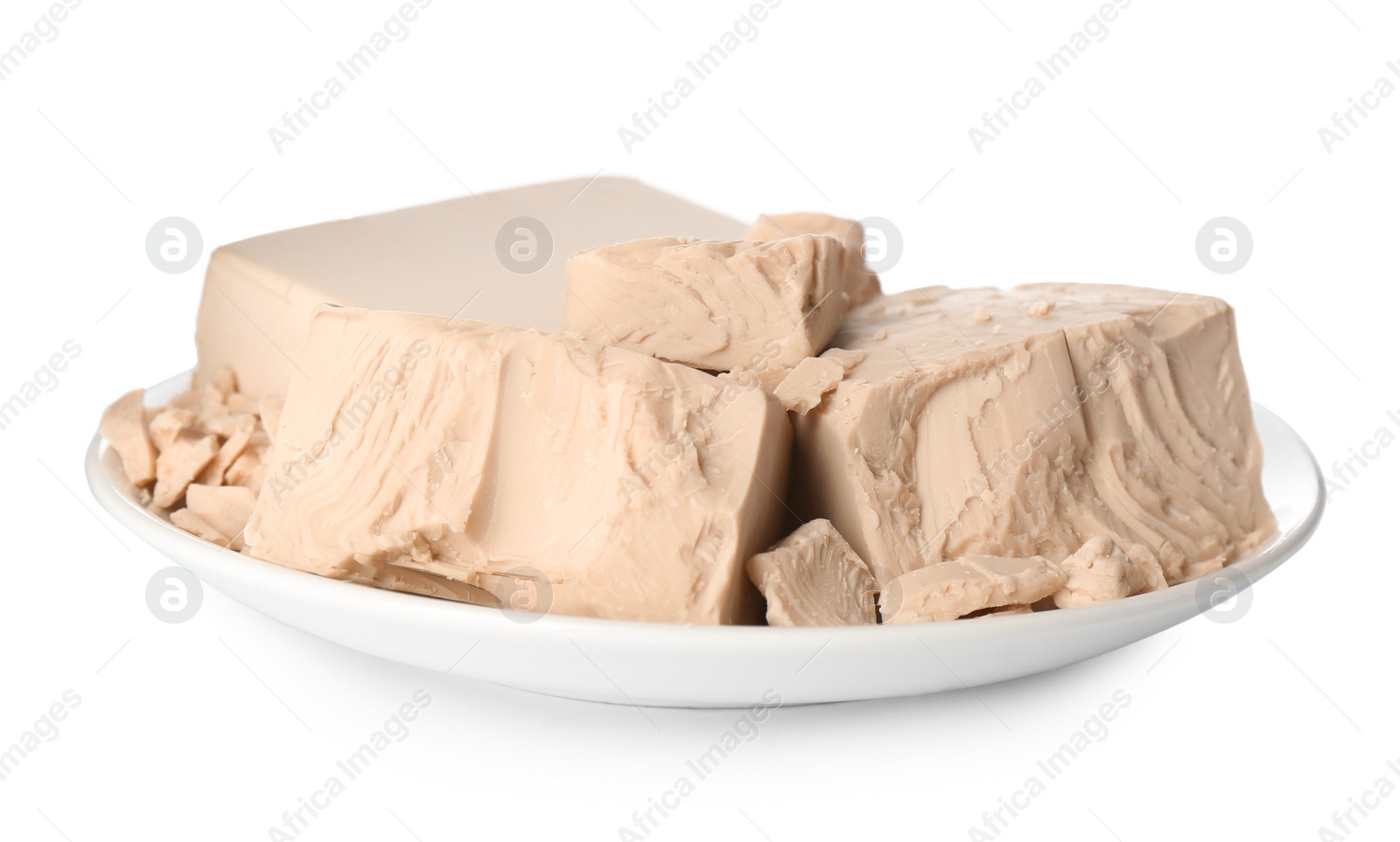 Photo of Plate with pieces of compressed yeast on white background