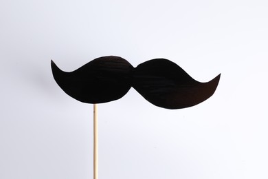 Fake paper mustache party prop against white background
