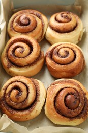 Photo of Tasty cinnamon rolls in baking dish, closeup