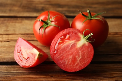 Fresh ripe red tomatoes on wooden table, closeup
