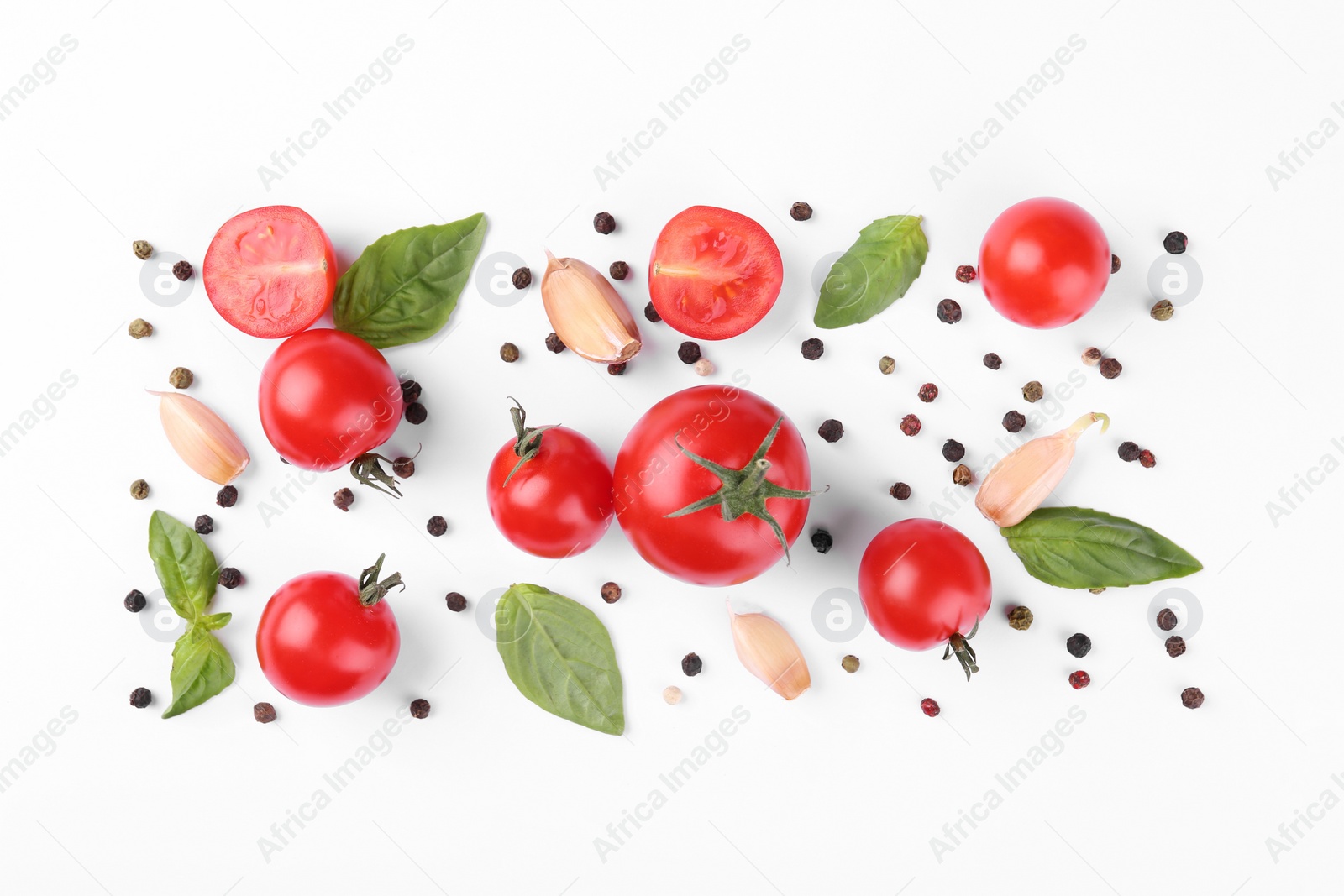 Photo of Flat lay composition with different whole and cut tomatoes on white background