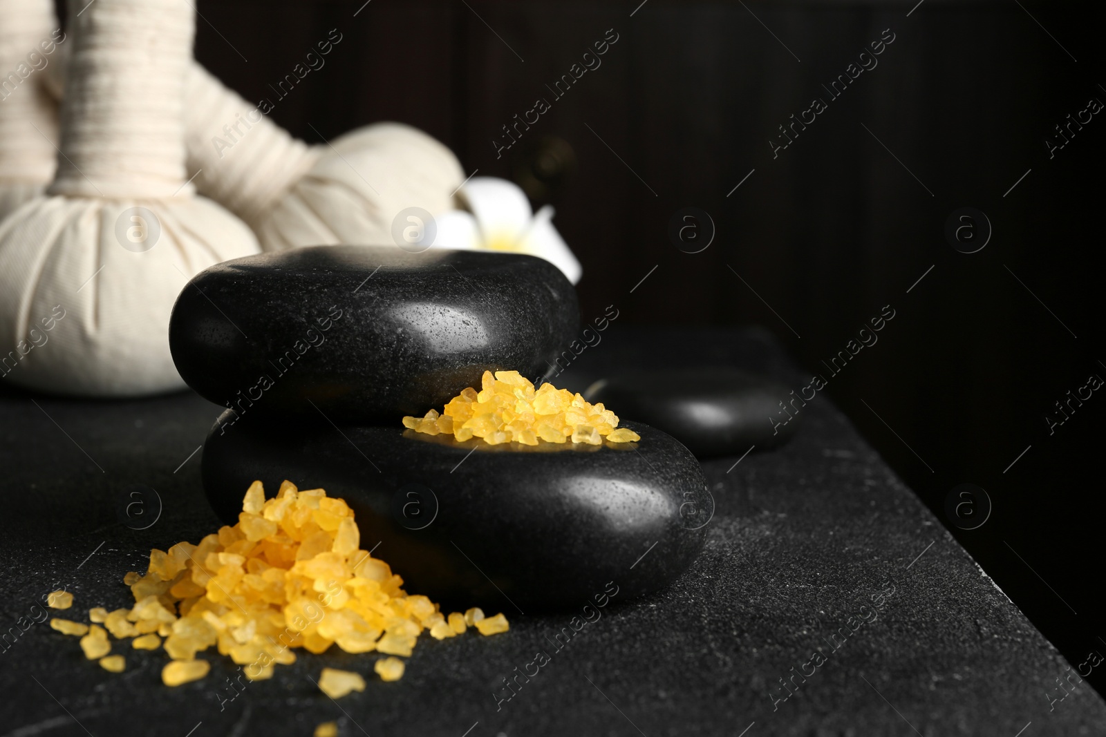 Photo of Beautiful composition with spa stones and bath salt on table. Space for text