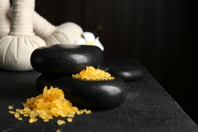 Beautiful composition with spa stones and bath salt on table. Space for text