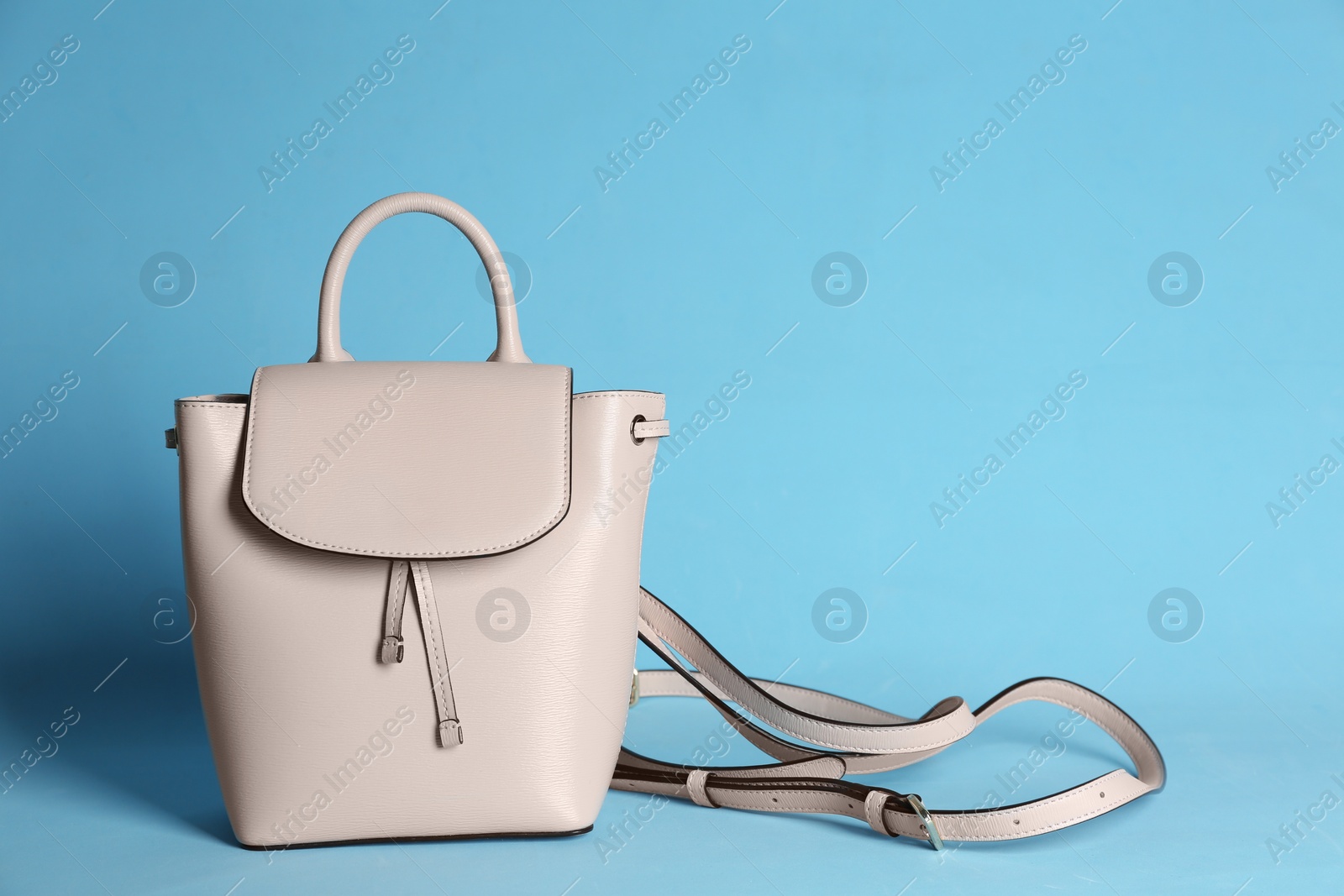 Photo of Stylish woman's bag on light blue background