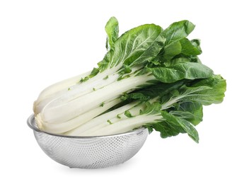 Photo of Fresh green pak choy cabbages with water drops in sieve on white background