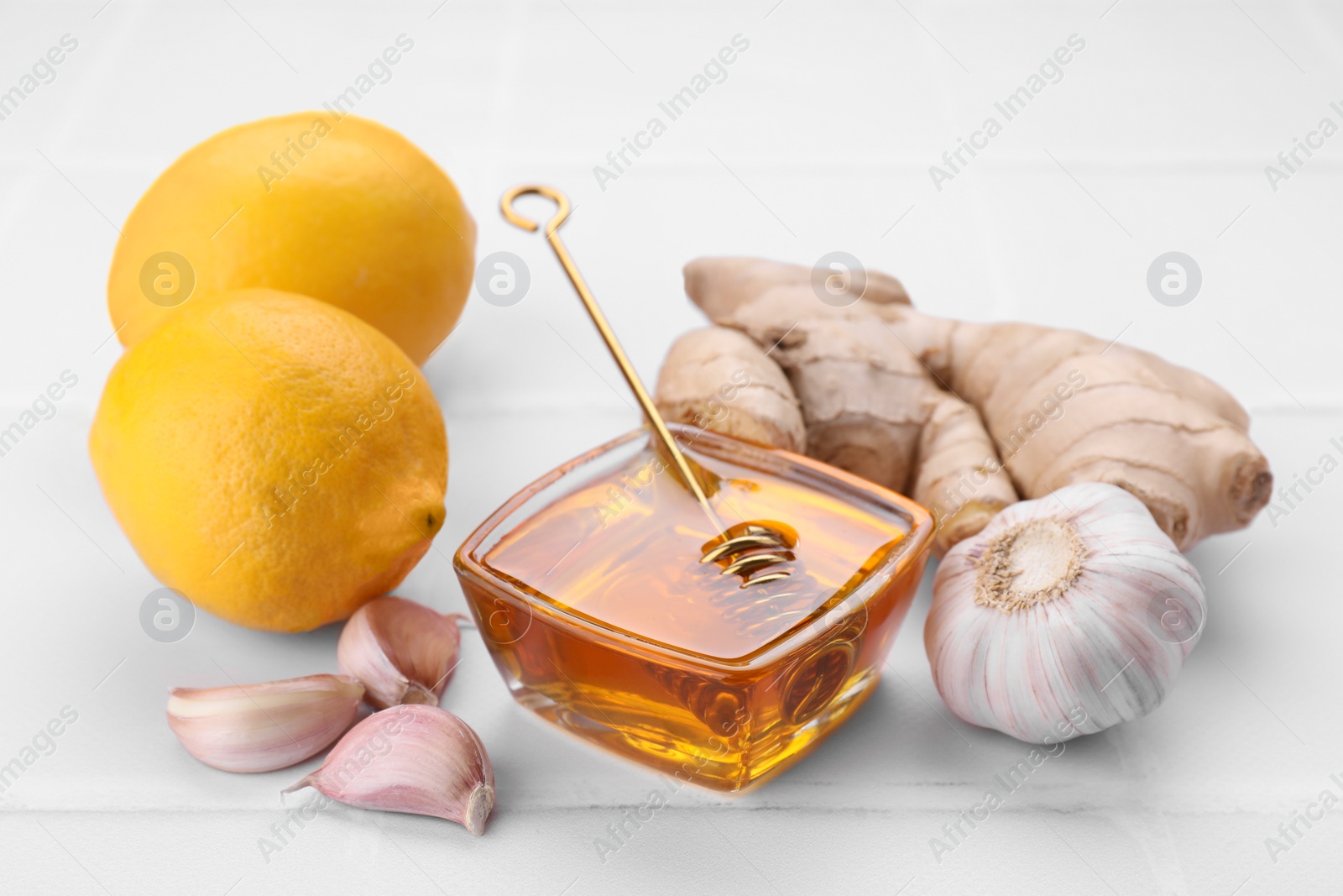 Photo of Cold remedies on white tiled table, closeup. Cough treatment