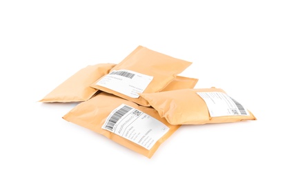 Photo of Padded envelopes on white background. Parcel delivery