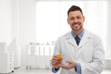 Photo of Professional pharmacist with pills in drugstore. Space for text