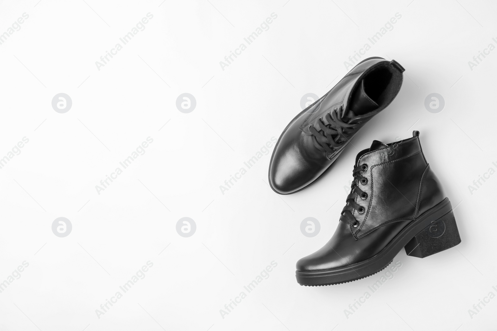 Photo of Stylish black female boots on white background, top view