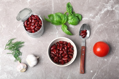 Photo of Flat lay composition with canned beans on grey background