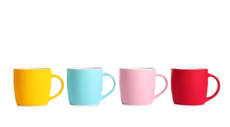 Different colorful cups on white background