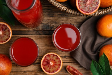 Photo of Tasty sicilian orange juice and fruits on wooden table, flat lay