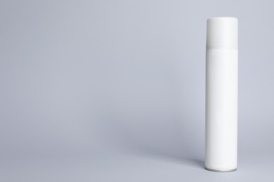 Photo of Bottle of dry shampoo on grey background, space for text