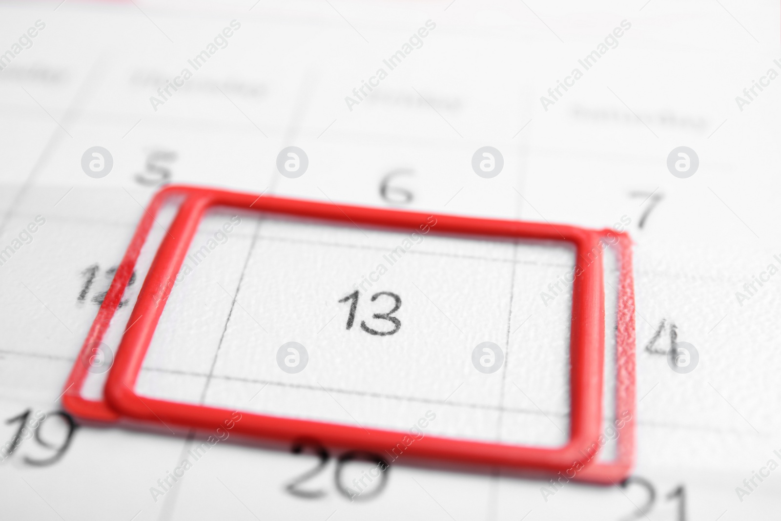 Photo of Closeup view of calendar page, focus on Friday 13. Bad luck superstition