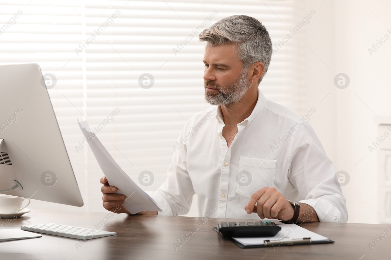 Photo of Professional accountant working at wooden desk in office