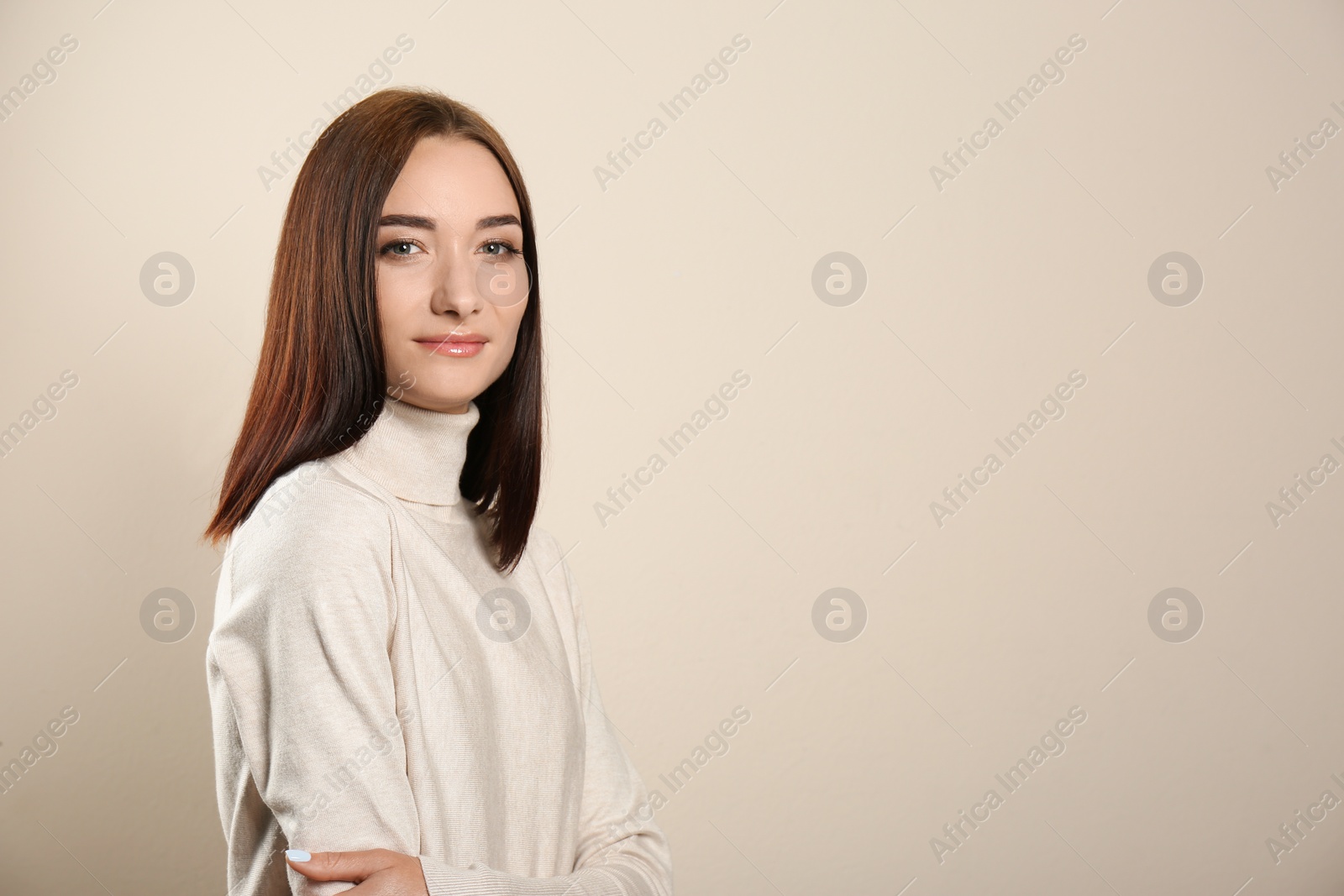 Photo of Portrait of pretty young woman with gorgeous chestnut hair on light background, space for text