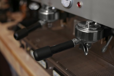 Photo of Modern electric coffee machine with portafilter, closeup