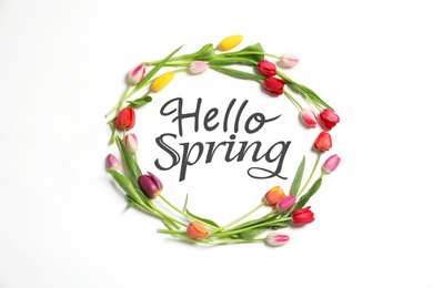 Image of Hello Spring. Frame made with beautiful tulips on white background, top view