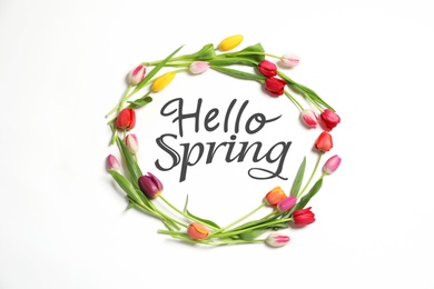 Hello Spring. Frame made with beautiful tulips on white background, top view