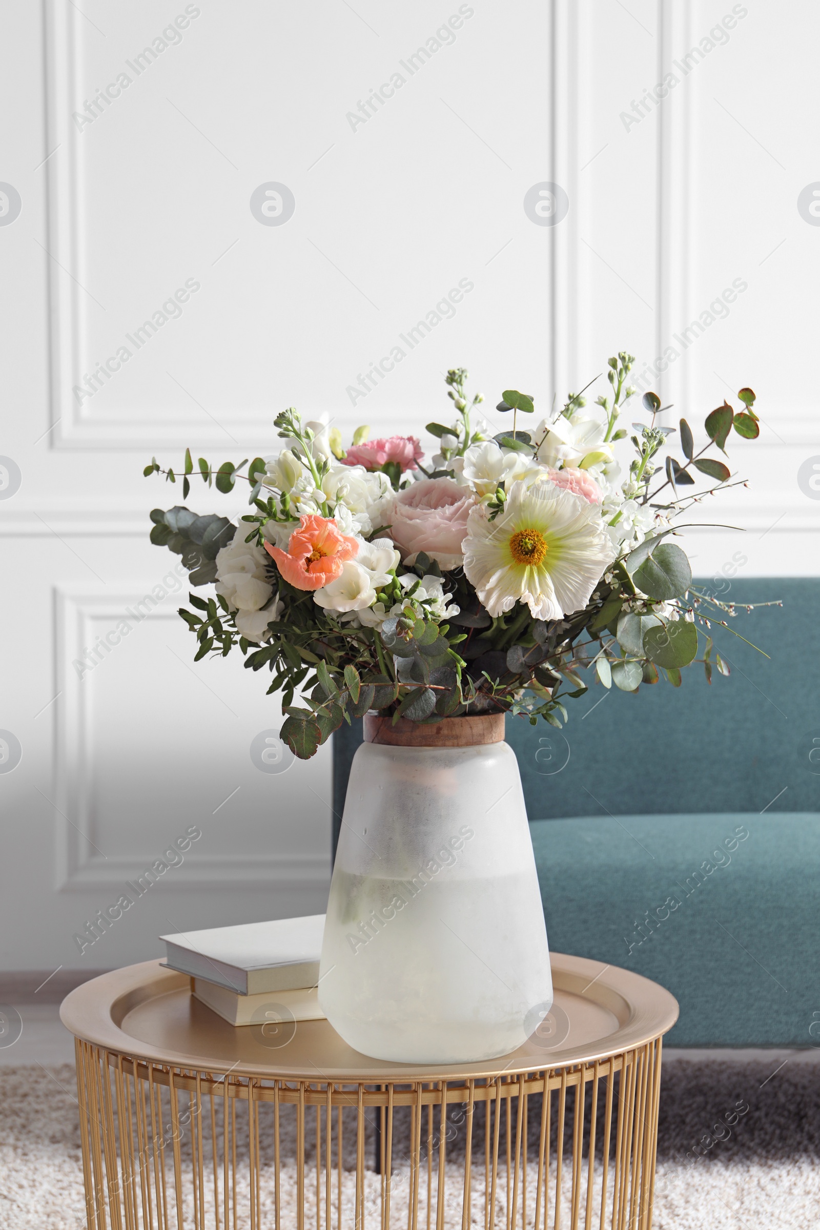 Photo of Bouquet of beautiful flowers on table indoors