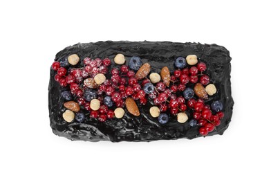 Photo of Delicious chocolate sponge cake with berries and nuts isolated on white, top view