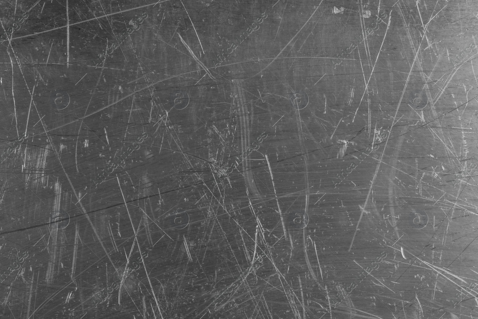 Photo of Texture of scratched metallic surface as background, closeup