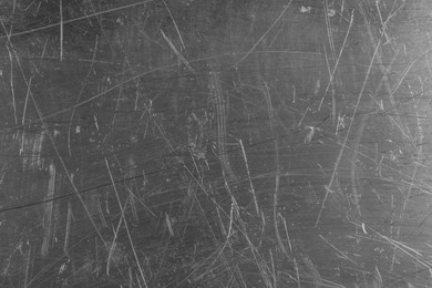 Photo of Texture of scratched metallic surface as background, closeup