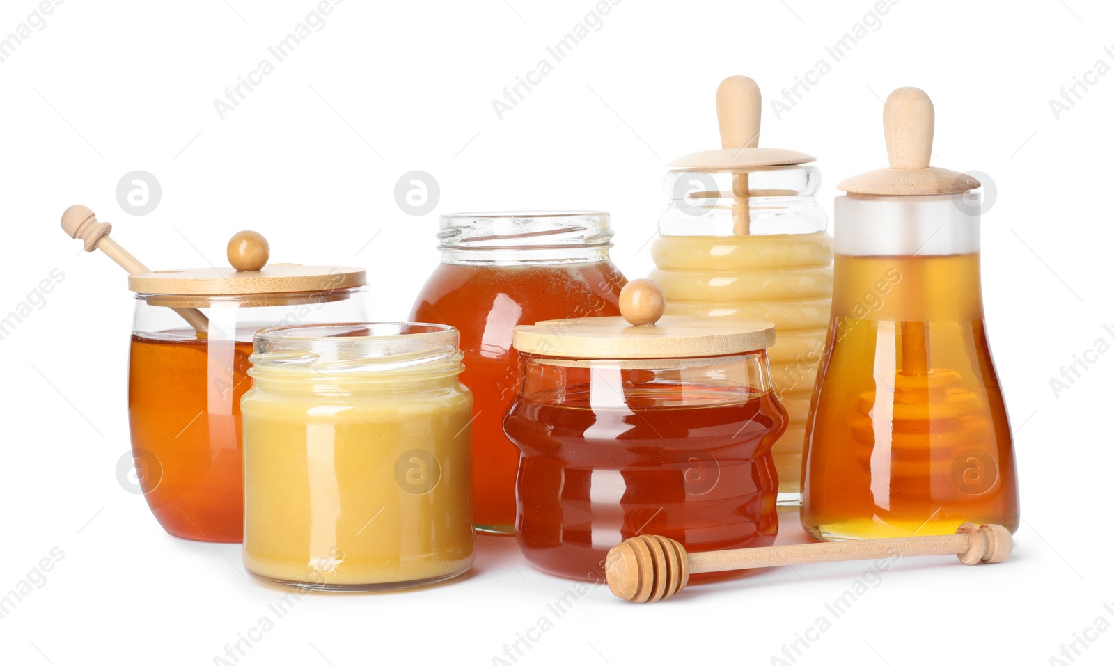 Photo of Glass jars with different types of sweet honey on white background