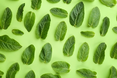 Flat lay composition with fresh mint leaves on color background