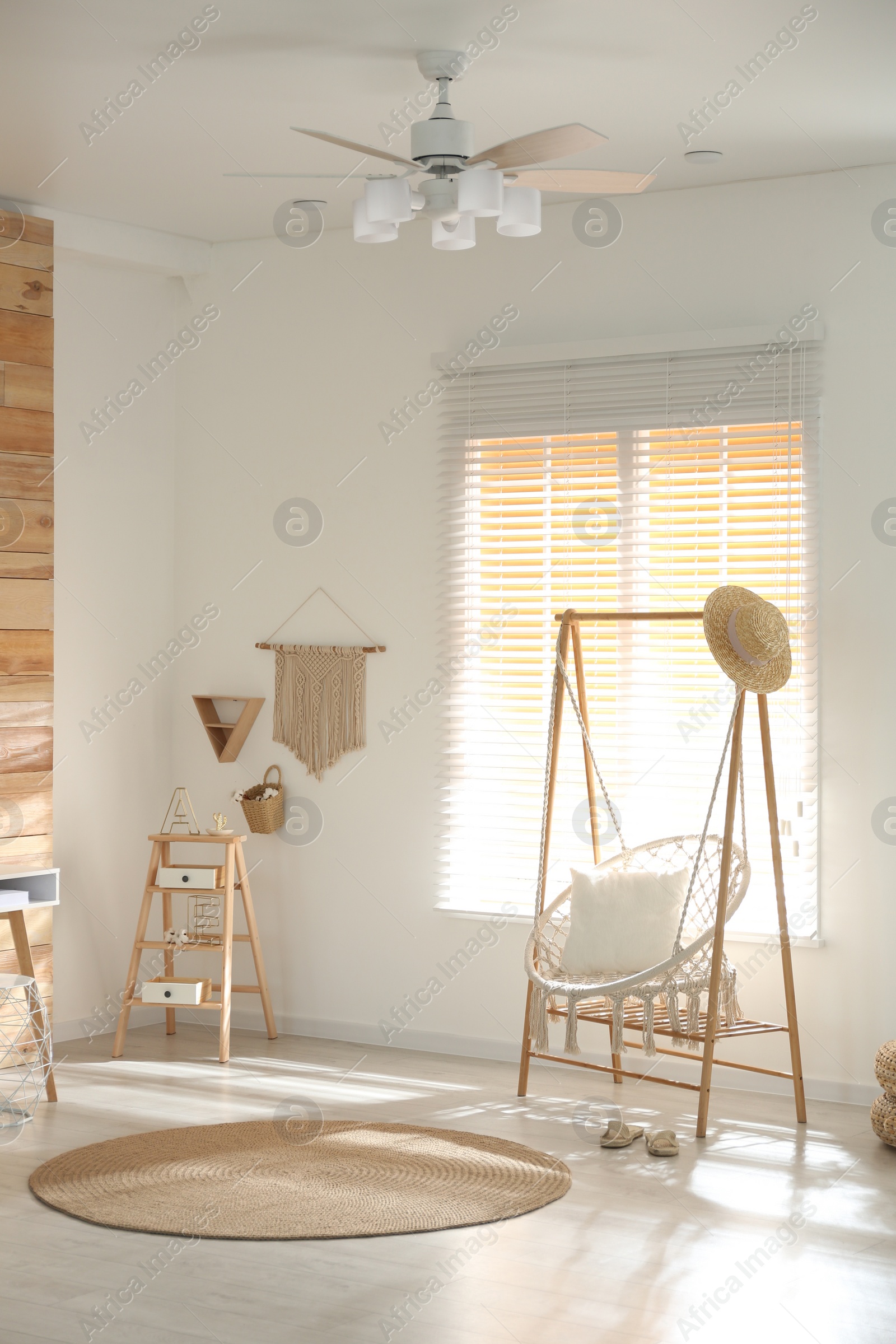 Photo of Comfortable hammock chair in stylish room. Home interior