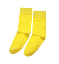 Photo of Yellow socks on white background, top view