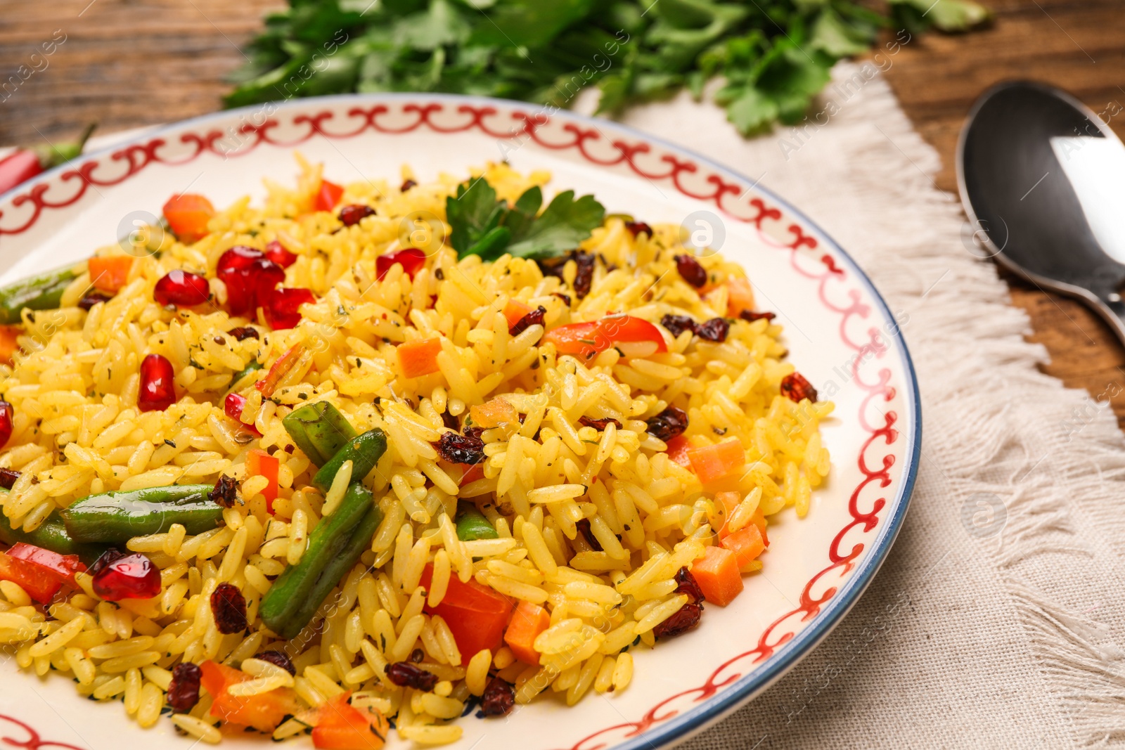 Photo of Tasty rice pilaf with vegetables on table, closeup