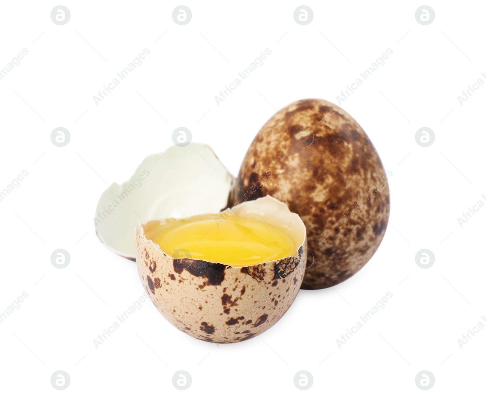 Photo of Whole and cracked quail eggs on white background