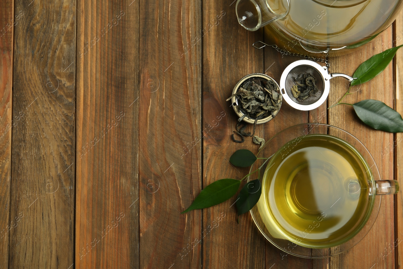 Photo of Flat lay composition with cup of green tea on wooden table. Space for text