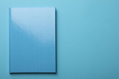 Photo of New bright planner on light blue background, top view. Space for text