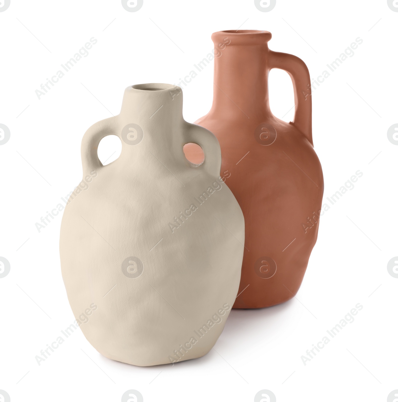 Photo of Two clay flagons with handles on white background