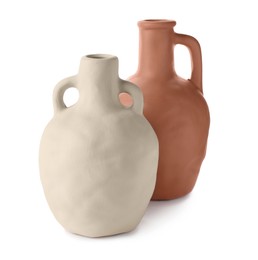 Photo of Two clay flagons with handles on white background
