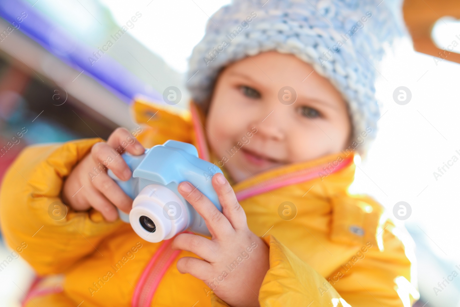 Photo of Cute little photographer outdoors, focus on hands with camera