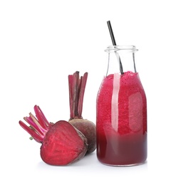 Photo of Bottle with beet juice and fresh vegetable on white background