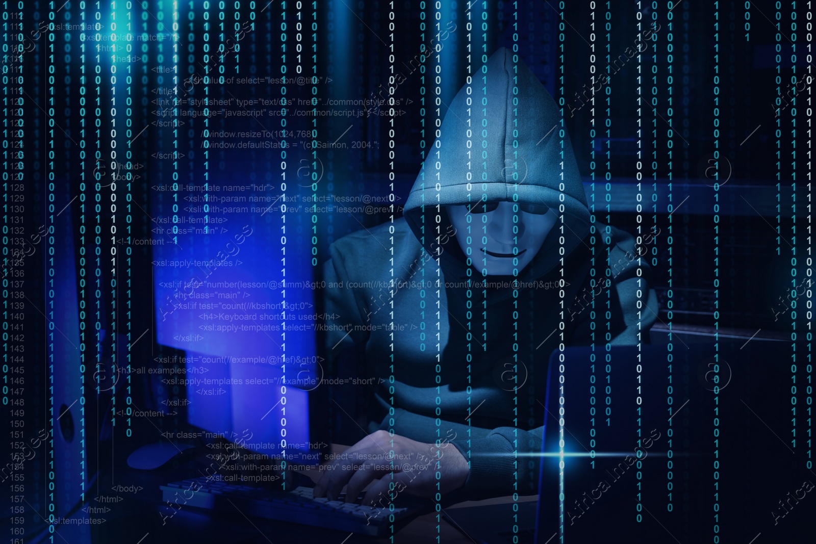 Image of Anonymous man in mask with computers, source and binary code in darkness