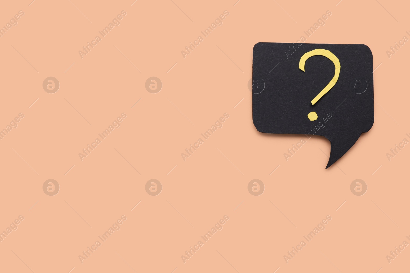 Photo of Paper speech bubble with question mark on beige background, top view. Space for text