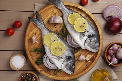 Photo of Flat lay composition with raw dorado fish on wooden table
