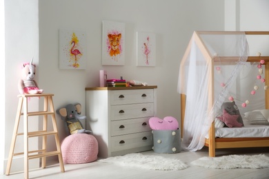Cute pictures and and stylish furniture in baby room interior