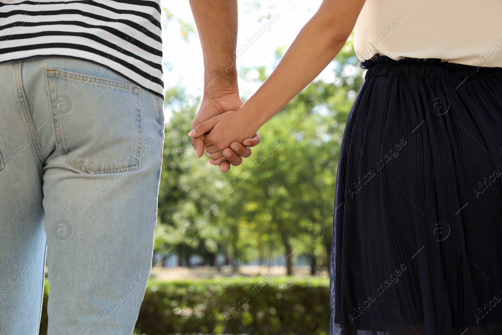 Photo of Lovely couple walking together in park on sunny day, closeup