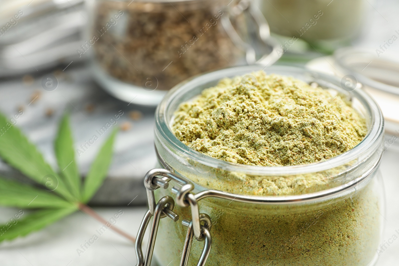 Photo of Jar of hemp protein powder on table, closeup