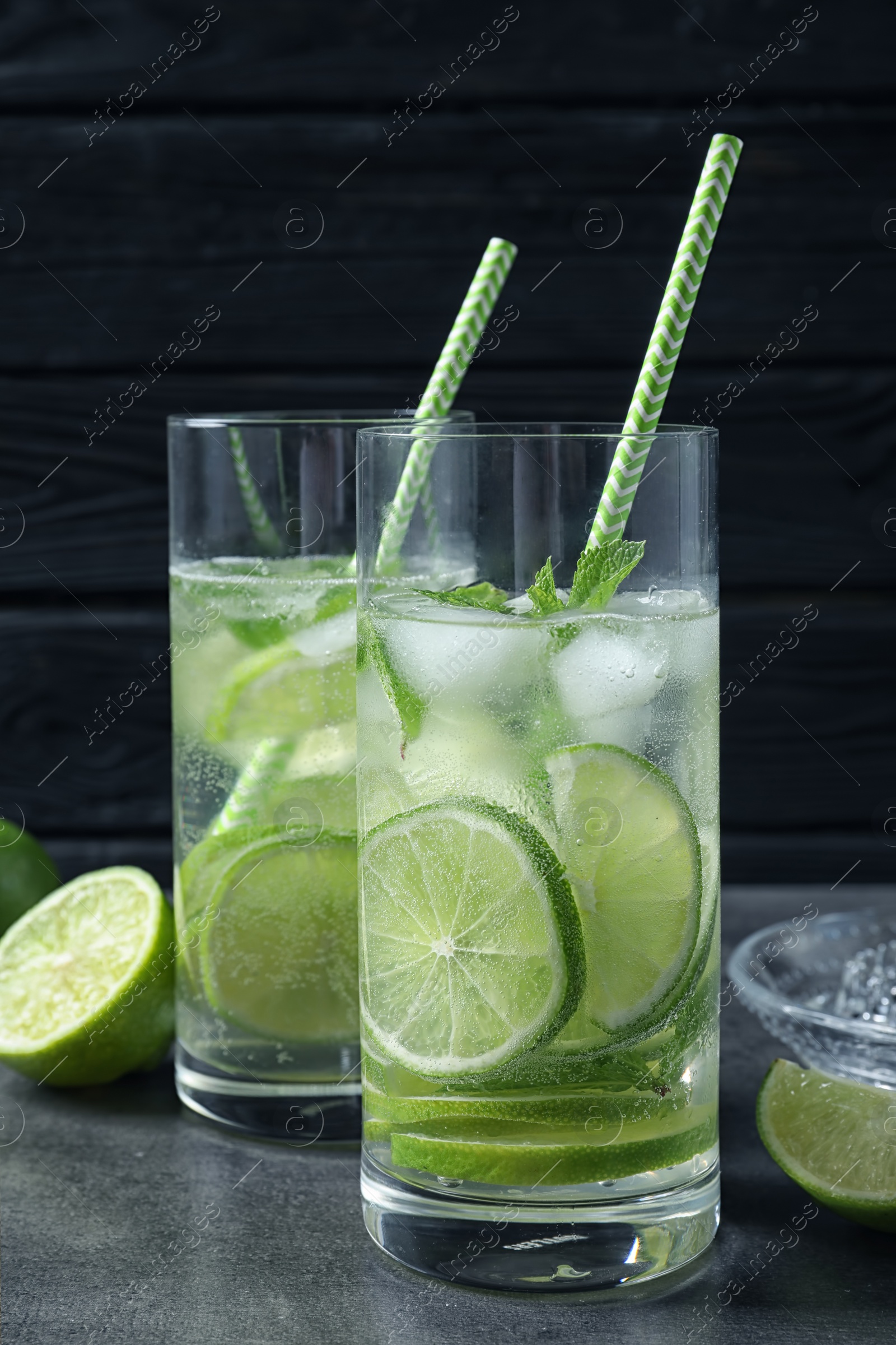 Photo of Glasses of natural lemonade with lime on table