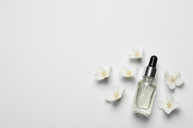 Photo of Jasmine essential and fresh flowers on white background, top view