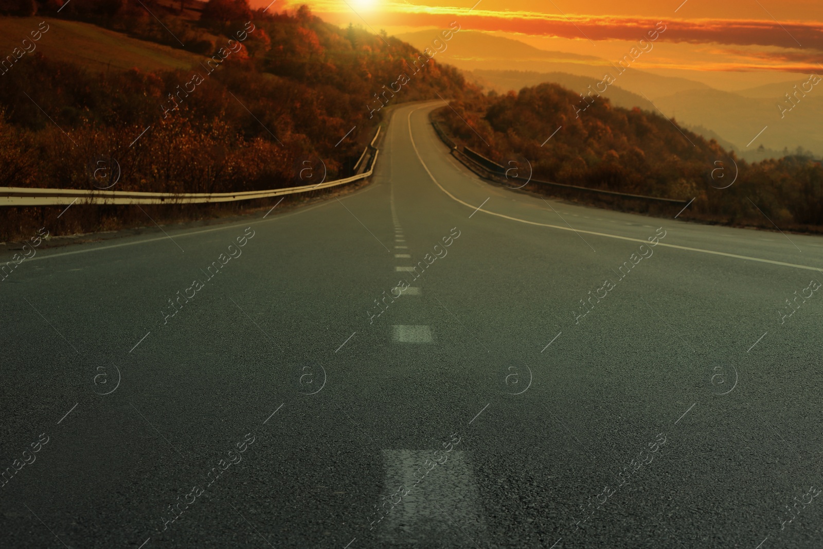 Image of Road trip. Beautiful view of asphalt highway at sunset 