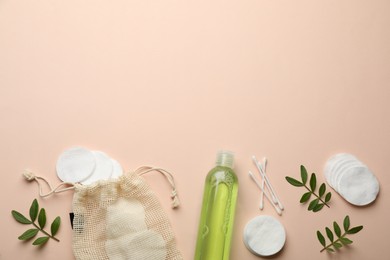 Photo of Cotton pads, swabs and makeup removal product on beige background, flat lay. Space for text