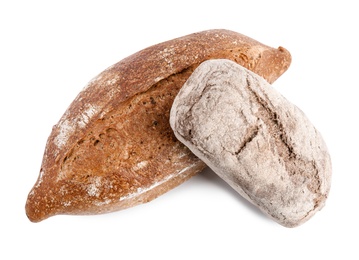 Loaves of different breads on white background, top view